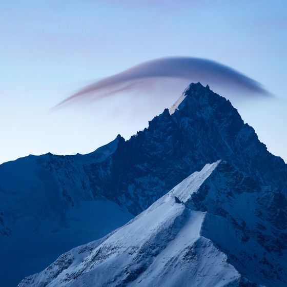 A blue mountain ridge under cloud